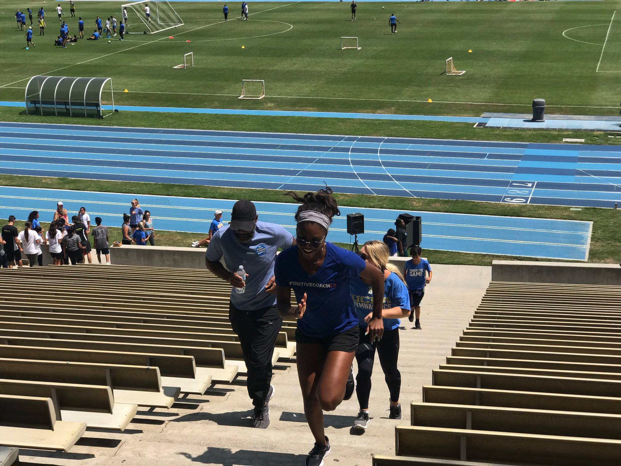 young people running up stadium stairs